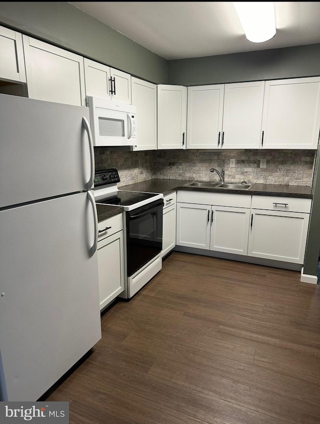 1004 Brinker Dr, Hagerstown, MD 21740 - kitchen featuring white appliances, dark countertops, and white cabinetry