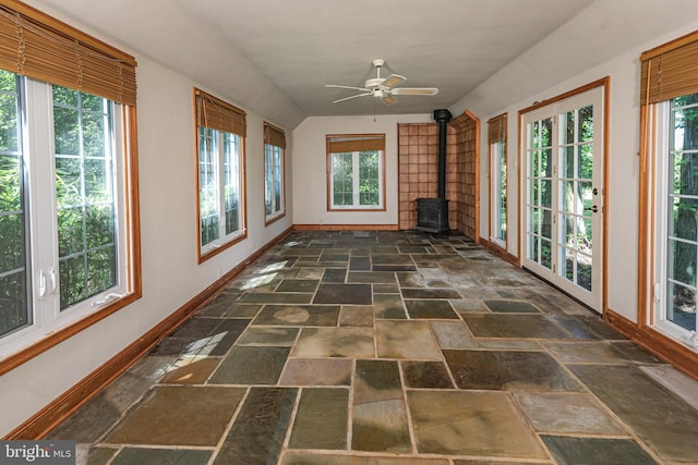 100 Carson Rd, Princeton, NJ 08540 - unfurnished sunroom with baseboards, stone tile flooring, a wood stove, french doors, and lofted ceiling