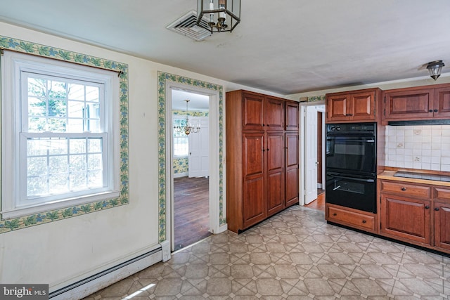 100 Carson Rd, Princeton, NJ 08540 - kitchen with baseboard heating, a chandelier, baseboards, under cabinet range hood, and decorative backsplash