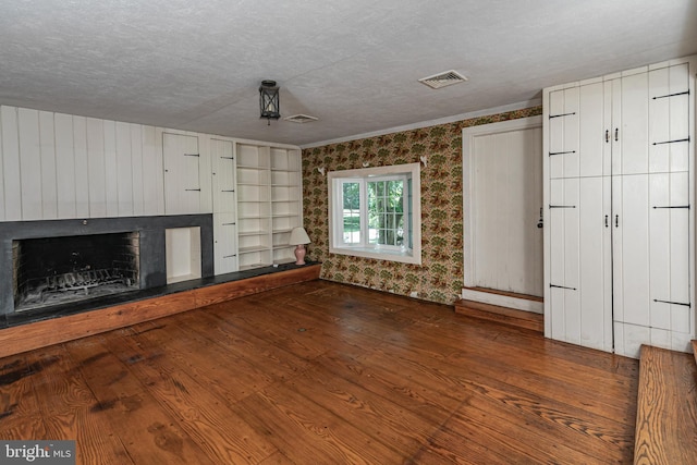 100 Carson Rd, Princeton, NJ 08540 - unfurnished living room featuring a fireplace, wallpapered walls, wood finished floors, a textured ceiling, and ornamental molding