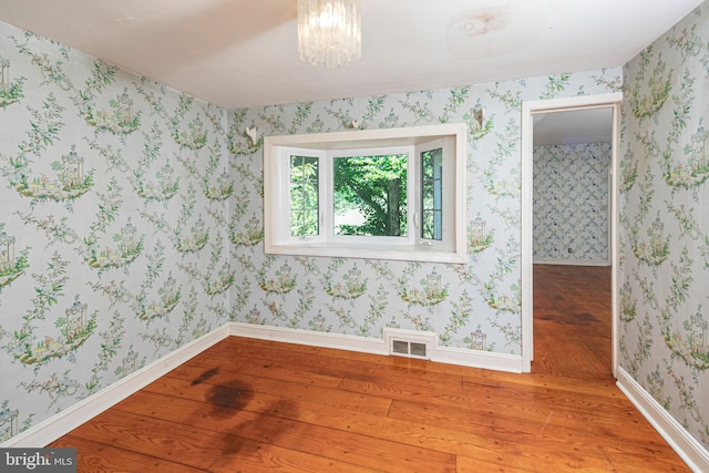 100 Carson Rd, Princeton, NJ 08540 - empty room featuring wood finished floors, baseboards, a chandelier, and wallpapered walls