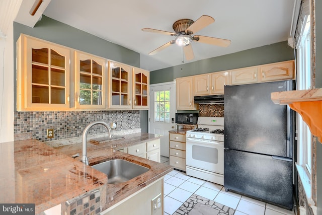 5919 Sefton Ave, Baltimore, MD 21214 - kitchen with black appliances, a sink, range hood, tasteful backsplash, and light tile patterned flooring