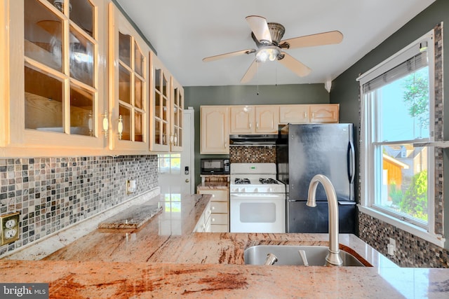 5919 Sefton Ave, Baltimore, MD 21214 - kitchen with black appliances, range hood, a sink, and plenty of natural light