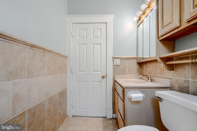 5919 Sefton Ave, Baltimore, MD 21214 - half bathroom with tile walls, vanity, toilet, tile patterned flooring, and wainscoting