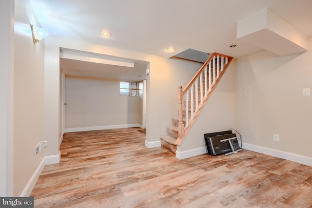 5919 Sefton Ave, Baltimore, MD 21214 - below grade area featuring wood finished floors, stairway, baseboards, and recessed lighting