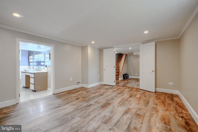 5919 Sefton Ave, Baltimore, MD 21214 - unfurnished living room with stairway, crown molding, light wood finished floors, recessed lighting, and baseboards