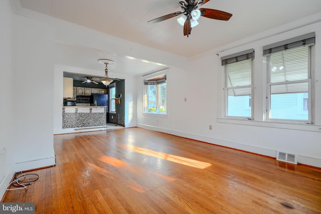 5919 Sefton Ave, Baltimore, MD 21214 - unfurnished living room with ceiling fan, baseboards, light wood-style floors, and crown molding