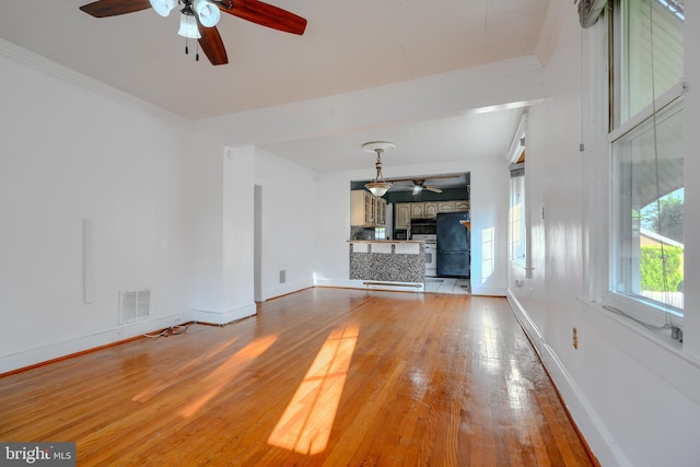 5919 Sefton Ave, Baltimore, MD 21214 - unfurnished living room featuring ceiling fan, light wood-style flooring, baseboards, crown molding, and a fireplace