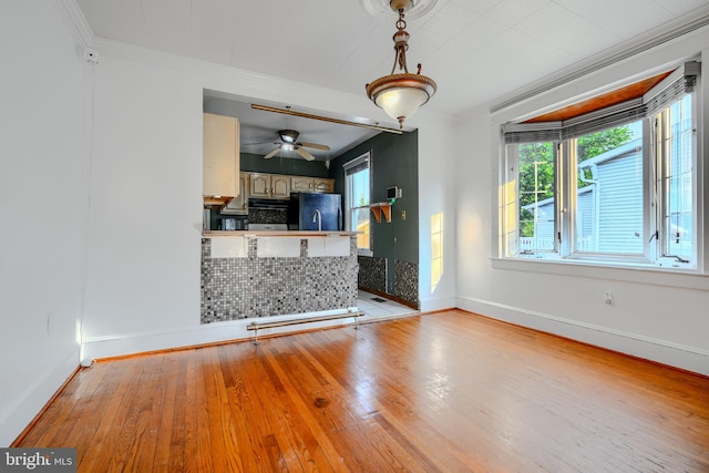5919 Sefton Ave, Baltimore, MD 21214 - unfurnished living room with light wood finished floors, baseboards, crown molding, and ceiling fan