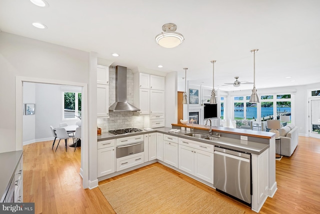 3442 Rockway Ave, Annapolis, MD 21403 - kitchen with stainless steel appliances, wall chimney range hood, a warming drawer, a sink, and open floor plan