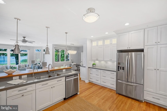 3442 Rockway Ave, Annapolis, MD 21403 - kitchen featuring appliances with stainless steel finishes, a sink, a ceiling fan, white cabinetry, and light wood-type flooring