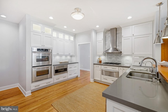 3442 Rockway Ave, Annapolis, MD 21403 - kitchen featuring wall chimney exhaust hood, a sink, stainless steel appliances, a warming drawer, and white cabinetry