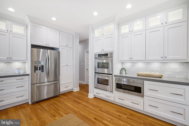 3442 Rockway Ave, Annapolis, MD 21403 - kitchen featuring appliances with stainless steel finishes, white cabinetry, backsplash, light wood-style floors, and recessed lighting