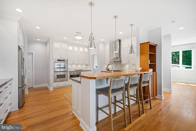 3442 Rockway Ave, Annapolis, MD 21403 - kitchen featuring wall chimney range hood, appliances with stainless steel finishes, decorative backsplash, baseboards, and recessed lighting