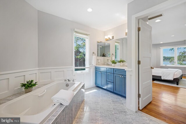 3442 Rockway Ave, Annapolis, MD 21403 - full bathroom featuring vanity, a garden tub, a decorative wall, wainscoting, and ensuite bathroom