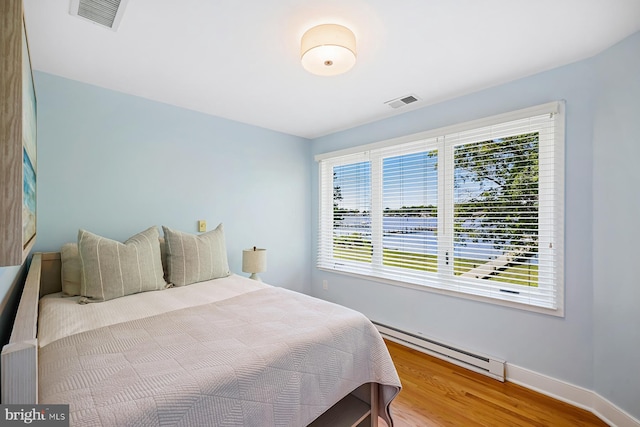 3442 Rockway Ave, Annapolis, MD 21403 - bedroom featuring a baseboard heating unit, wood finished floors, and baseboards
