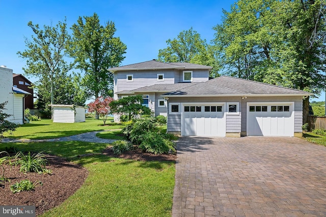 3442 Rockway Ave, Annapolis, MD 21403 - view of front of home featuring decorative driveway, a front yard, a garage, an outdoor structure, and roof with shingles