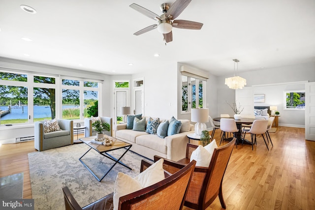 3442 Rockway Ave, Annapolis, MD 21403 - living room with light wood-type flooring, ceiling fan, a baseboard radiator, recessed lighting, and a chandelier