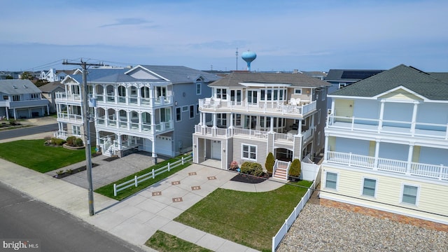 1107 Ocean Ave, Brigantine, NJ 08203 - view of front of home with a residential view, concrete driveway, and a front yard