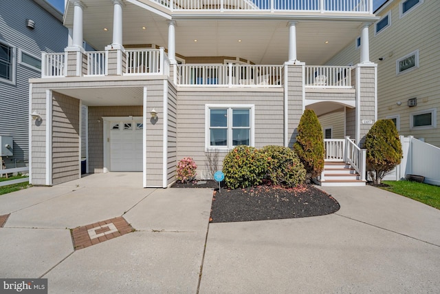 1107 Ocean Ave, Brigantine, NJ 08203 - view of front of property featuring an attached garage, driveway, and a balcony