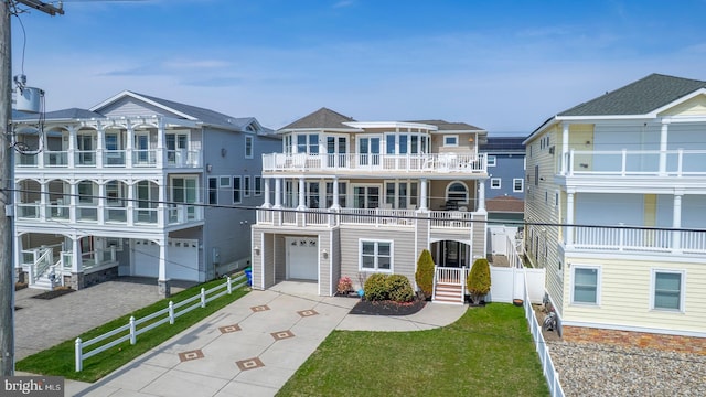 1107 Ocean Ave, Brigantine, NJ 08203 - view of front of home with concrete driveway, an attached garage, and a balcony