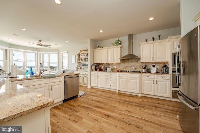 1107 Ocean Ave, Brigantine, NJ 08203 - kitchen with wall chimney range hood, appliances with stainless steel finishes, a ceiling fan, decorative backsplash, and recessed lighting