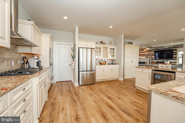 1107 Ocean Ave, Brigantine, NJ 08203 - kitchen featuring appliances with stainless steel finishes, wall chimney range hood, beverage cooler, backsplash, and open floor plan