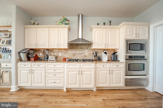 1107 Ocean Ave, Brigantine, NJ 08203 - kitchen featuring appliances with stainless steel finishes, wall chimney range hood, a warming drawer, and light stone counters