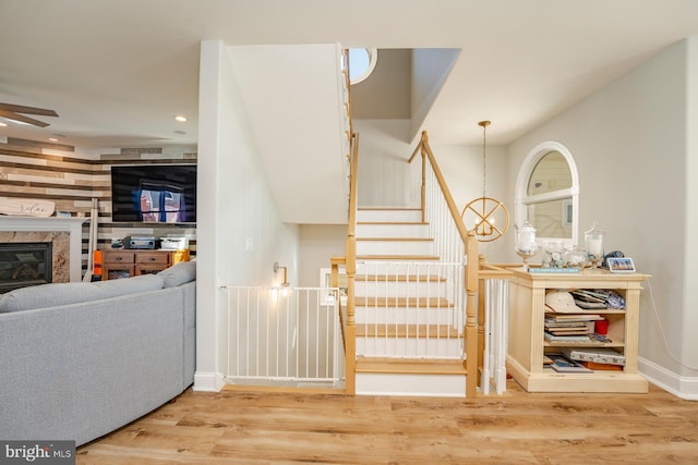 1107 Ocean Ave, Brigantine, NJ 08203 - stairs with wood finished floors, a high end fireplace, ceiling fan, recessed lighting, and baseboards