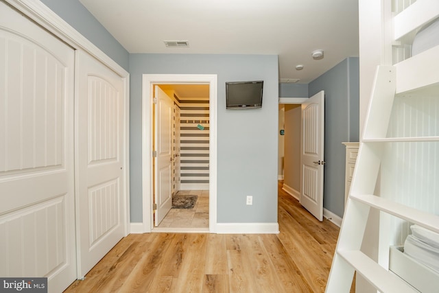 1107 Ocean Ave, Brigantine, NJ 08203 - unfurnished bedroom featuring a closet, light wood-style floors, and baseboards