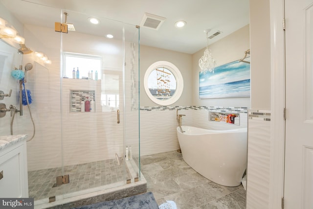 1107 Ocean Ave, Brigantine, NJ 08203 - full bathroom featuring tile walls, a soaking tub, a stall shower, a chandelier, and recessed lighting
