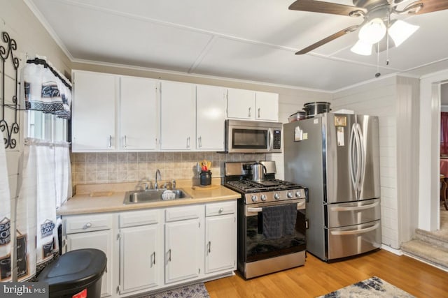 137 2nd St, Bordentown, NJ 08505 - kitchen with appliances with stainless steel finishes, a sink, light countertops, white cabinets, and light wood-type flooring