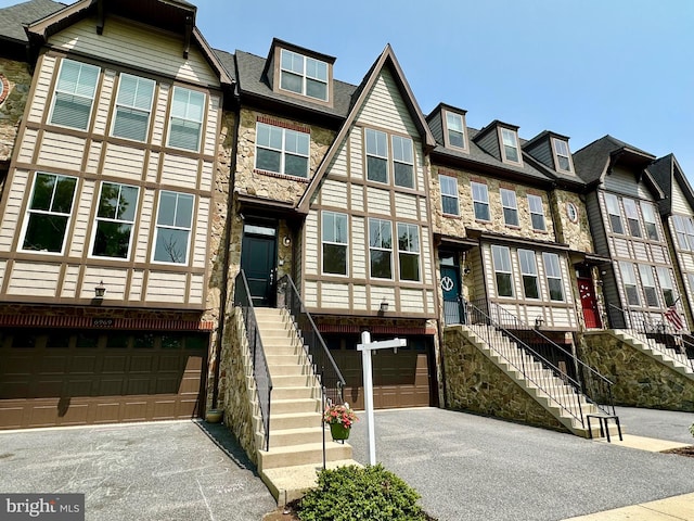 6967 Country Club Ter, New Market, MD 21774 - view of property with an attached garage, stone siding, asphalt driveway, and stairs