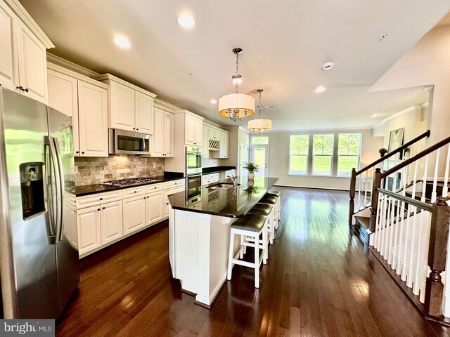 6967 Country Club Ter, New Market, MD 21774 - kitchen with stainless steel appliances, dark wood finished floors, recessed lighting, backsplash, and a kitchen island with sink