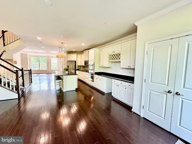 6967 Country Club Ter, New Market, MD 21774 - kitchen featuring dark countertops, stainless steel appliances, ornamental molding, recessed lighting, and dark wood finished floors