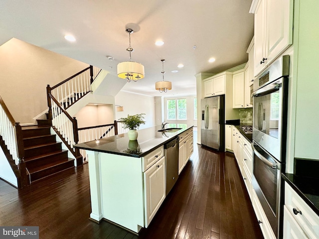 6967 Country Club Ter, New Market, MD 21774 - kitchen featuring appliances with stainless steel finishes, dark countertops, dark wood finished floors, recessed lighting, and a sink