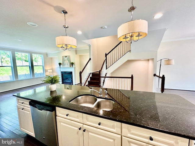 6967 Country Club Ter, New Market, MD 21774 - kitchen with stainless steel dishwasher, a sink, crown molding, open floor plan, and a glass covered fireplace