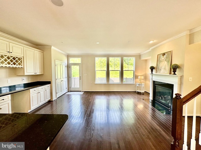 6967 Country Club Ter, New Market, MD 21774 - unfurnished living room featuring dark wood finished floors, a glass covered fireplace, ornamental molding, and baseboards
