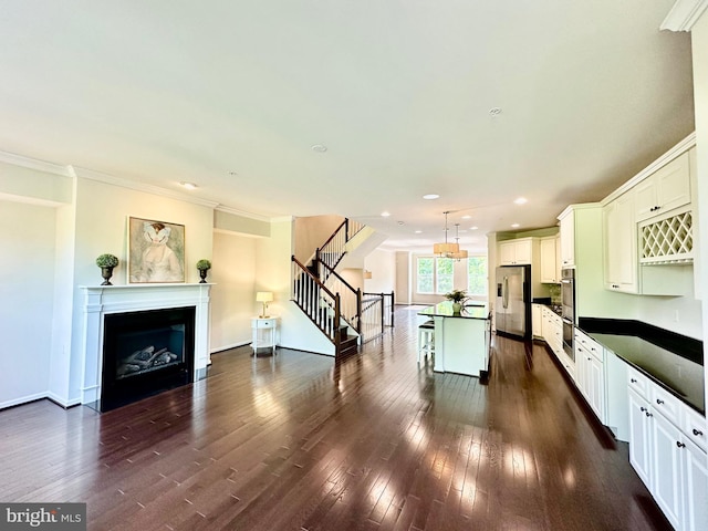 6967 Country Club Ter, New Market, MD 21774 - kitchen with stainless steel appliances, dark countertops, dark wood finished floors, a breakfast bar, and recessed lighting