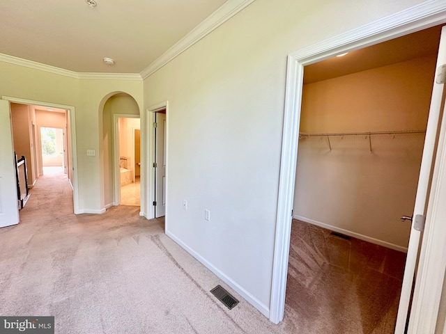 6967 Country Club Ter, New Market, MD 21774 - unfurnished bedroom featuring carpet flooring, arched walkways, crown molding, a closet, and baseboards