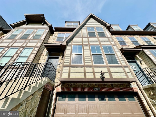 6967 Country Club Ter, New Market, MD 21774 - view of side of home with stone siding, a balcony, and a garage
