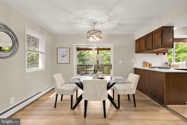 5404 Nedra Ave, Alexandria, VA 22310 - dining space with a baseboard heating unit, light wood-style flooring, and a chandelier