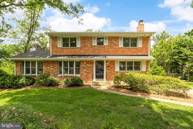 5404 Nedra Ave, Alexandria, VA 22310 - traditional-style home featuring a chimney, a front lawn, and brick siding