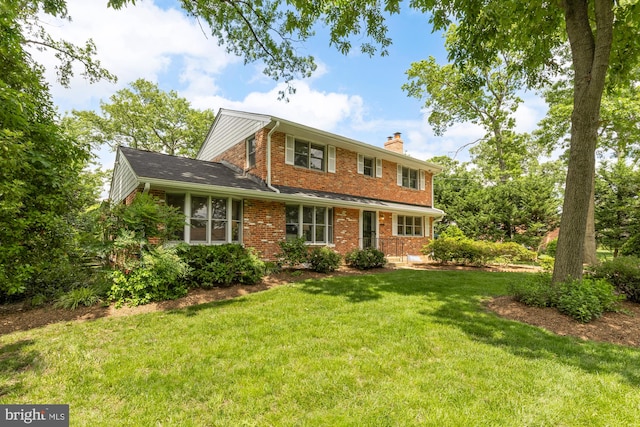 5404 Nedra Ave, Alexandria, VA 22310 - traditional-style house featuring brick siding, a chimney, and a front lawn