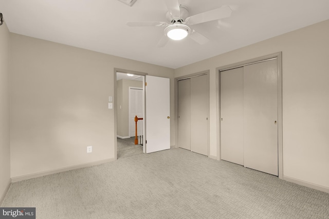 5404 Nedra Ave, Alexandria, VA 22310 - unfurnished bedroom featuring multiple closets, light colored carpet, baseboards, and ceiling fan