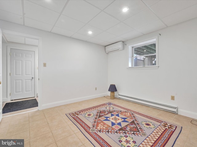 2054 Buckskin Cv, Auburn, PA 17922 - finished basement with a baseboard heating unit, an AC wall unit, light tile patterned flooring, a paneled ceiling, and baseboards