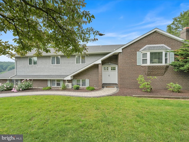 2054 Buckskin Cv, Auburn, PA 17922 - view of front of home with a front yard, brick siding, and a cooling unit