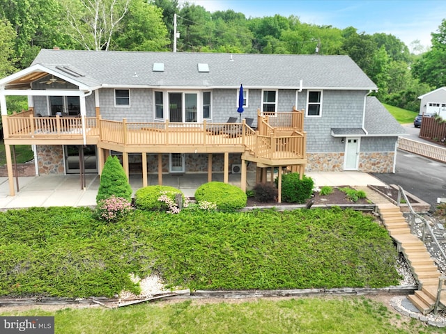 2054 Buckskin Cv, Auburn, PA 17922 - rear view of house with stairs, stone siding, roof with shingles, and a wooden deck