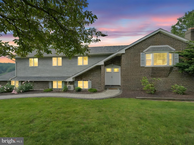2054 Buckskin Cv, Auburn, PA 17922 - view of front facade with a front yard, brick siding, and ac unit