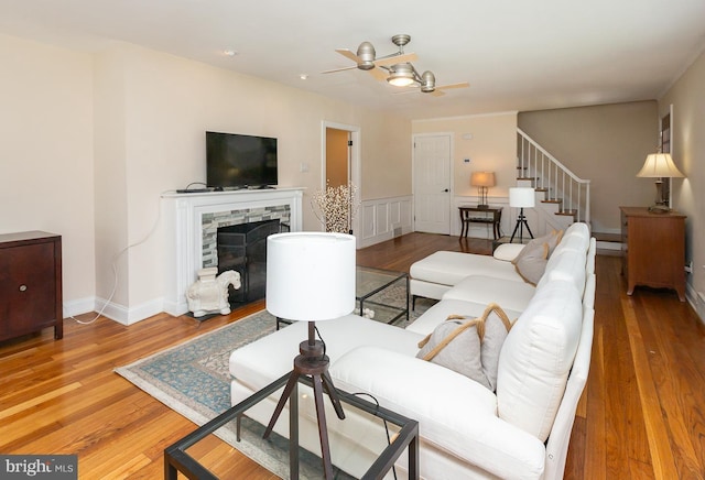 921 Coopertown Rd, Bryn Mawr, PA 19010 - living area with stairway, wood finished floors, ceiling fan, and a stone fireplace